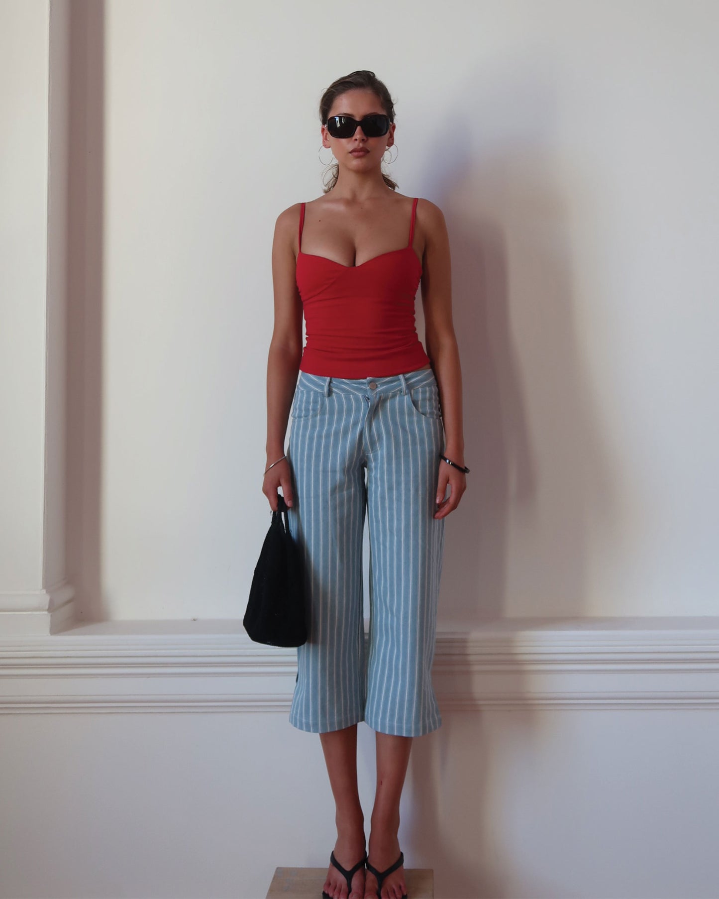 Women's low waisted pant in denim stripe featuring 3/4 length and straight leg fit. 